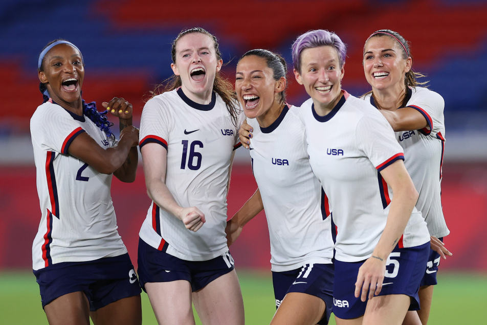 Members of the women's soccer team celebrate at the Tokyo 2020 Olympic Games.